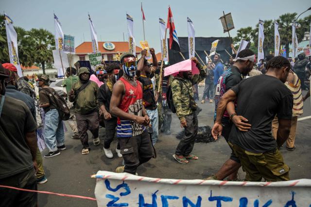 Papuan students dance as they take part in a protest calling for the independence of Papua province in Surabaya on December 1, 2025, to coincide with the anniversary of the Free Papua Movement. (Photo by JUNI KRISWANTO / AFP)