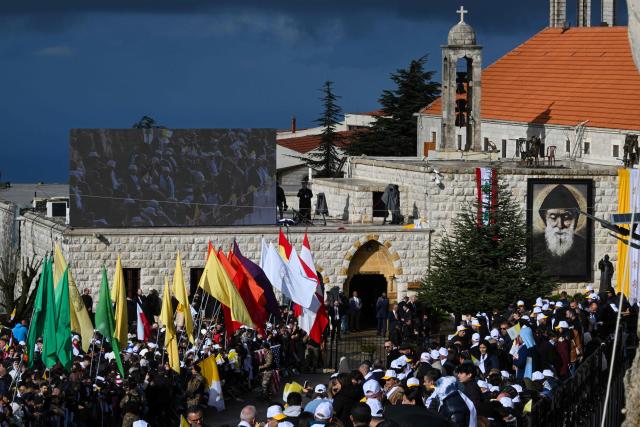 People wait to catch a glimpse of Pope Leo XIV during his visit to the tomb of Saint Charbel Makhlouf in Annaya, north of Beirut, on December 1, 2025. Pope Leo XIV is set to urge peace and unity on his second day in Lebanon on December 1, 2025, bringing a message of hope to young people whose faith in their crisis-hit country has dwindled. (Photo by JOSEPH EID / AFP)