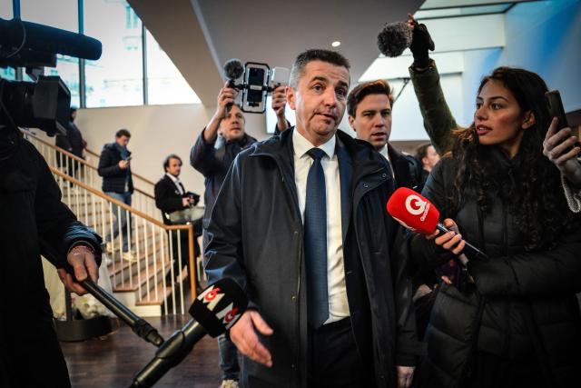 Mayor of Saint Etienne Gaël Perdriau (C) arrives to attend the summary proceedings of the trial of the sex-tape blackmail case at the courthouse in Lyon on December 1 2025. Lyon court deliberates on December 1, 2025 in the trial over the so-called "sex-tape" case of Saint-Etienne's town hall. At the heart of the trial is the mayor of the town, Gael Perdriau, 53, accused of ordering a video of his former deputy Gilles Artigues with a male prostitute, and tried alongside former associates for blackmail, criminal conspiracy and embezzlement of public funds. (Photo by OLIVIER CHASSIGNOLE / AFP)