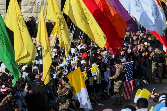 Lebanese soldiers stand guard as people wait to catch a glimpse of Pope Leo XIV during his visit to the tomb of Saint Charbel Makhlouf in Annaya, north of Beirut, on December 1, 2025. Pope Leo XIV is set to urge peace and unity on his second day in Lebanon on December 1, 2025, bringing a message of hope to young people whose faith in their crisis-hit country has dwindled. (Photo by JOSEPH EID / AFP)
