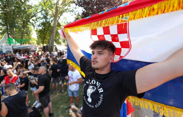 (FILES) Fans of Croatian nationalist singer Marko Perkovic Thompson, known for his sympathies for the country's World War II Nazi-allied regime, gather next to the Zagreb hippodrome where he will give a concert expected by a crowd of some 450,000 people, in Zagreb, on July 5, 2025. The proliferation of ultranationalist rhetoric and the rise of historical revisionism in Croatia in 2025 threaten to reopen the wounds of a region still scarred by intercommunal wars, several observers warn. From the giant concert of Thompson, a legend of Croatian music known for his pro-Nazi sympathies, which gathered 450,000 people in Zagreb in July 2025, to the attack by hooligans on Serbian cultural events in November, tensions have been escalating in recent months, notes Florian Bieber from the Austrian University of Graz. (Photo by DAMIR SENCAR / AFP)