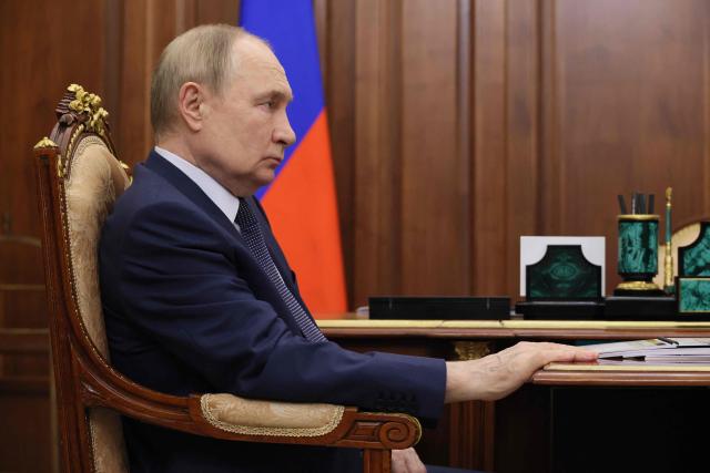 In this pool photograph distributed by the Russian state agency Sputnik, Russia's President Vladimir Putin attends a meeting with Russia's prison service head at the Kremlin in Moscow on December 1, 2025. (Photo by Gavriil Grigorov / POOL / AFP)