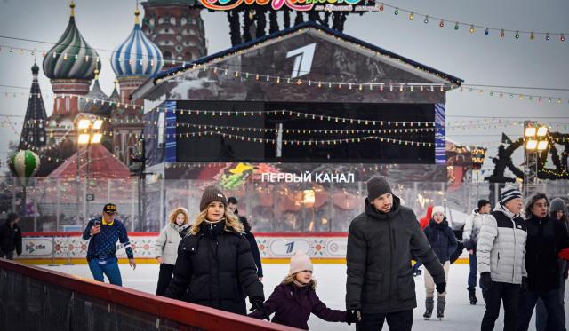 People enjoy skating at a temporary open air ice rink in the center of Red Square, with St. Basil's Cathedral seen in the background, in Moscow on December 1, 2025. (Photo by Alexander NEMENOV / AFP)