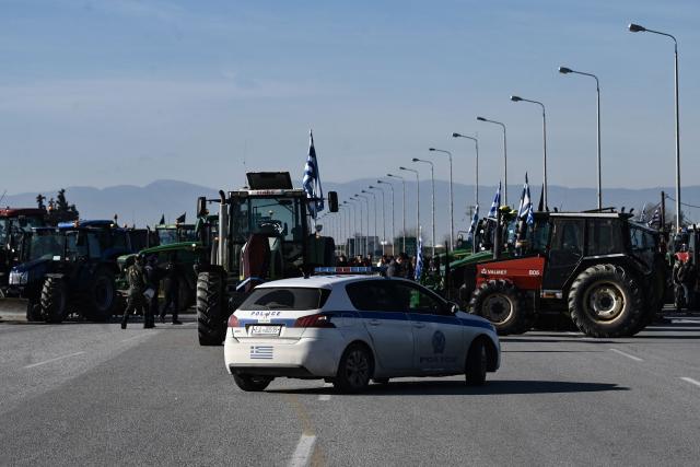 Farmers block a national highway with tractors to protest over the reduced and delayed payment of European Union subsidies, at the Malgara tolls near Thessaloniki on December 1, 2025. (Photo by Sakis Mitrolidis / AFP)