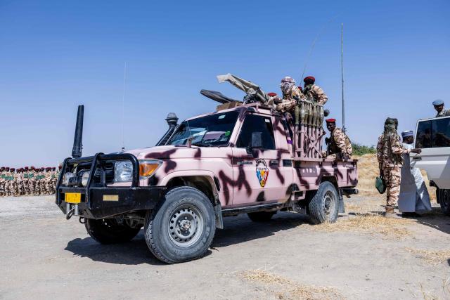 Chadian soldiers from the anti-terrorist unit wait in the back of a vehicle at the Baga Sola military base, Lake Chad Province, Chad, on 26 November, 2025. The new commander-in-chief of the Multinational Joint Task Force (MNJTF) for counter-jihadist efforts in the Lake Chad Basin assured on Wednesday to AFP that securing waterways is a priority mission in this border region of Central Africa. Establishing secure navigation corridors is "one of the main priorities," according to General Saidou Tanko Audu, who has been leading the regional counter-jihadist force since mid-November. (Photo by Joris Bolomey / AFP)