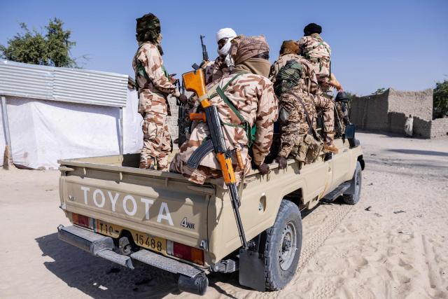 Chadian soldiers from the anti-terrorist unit  ontravel the back of a vehicle at the Baga Sola military base, Lake Chad Province, Chad, on 26 November, 2025. The new commander-in-chief of the Multinational Joint Task Force (MNJTF) for counter-jihadist efforts in the Lake Chad Basin assured on Wednesday to AFP that securing waterways is a priority mission in this border region of Central Africa. Establishing secure navigation corridors is "one of the main priorities," according to General Saidou Tanko Audu, who has been leading the regional counter-jihadist force since mid-November. (Photo by Joris Bolomey / AFP)