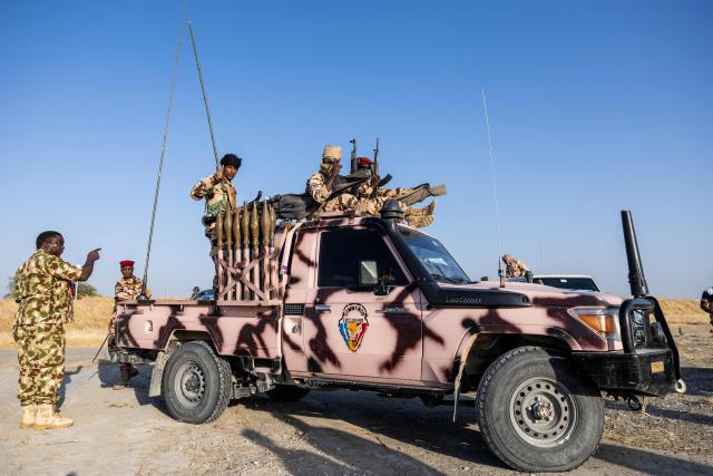 Chadian soldiers from the anti-terrorist unit wait in the back of a vehicle at the Baga Sola military base, Lake Chad Province, Chad, on 26 November, 2025. The new commander-in-chief of the Multinational Joint Task Force (MNJTF) for counter-jihadist efforts in the Lake Chad Basin assured on Wednesday to AFP that securing waterways is a priority mission in this border region of Central Africa. Establishing secure navigation corridors is "one of the main priorities," according to General Saidou Tanko Audu, who has been leading the regional counter-jihadist force since mid-November. (Photo by Joris Bolomey / AFP)