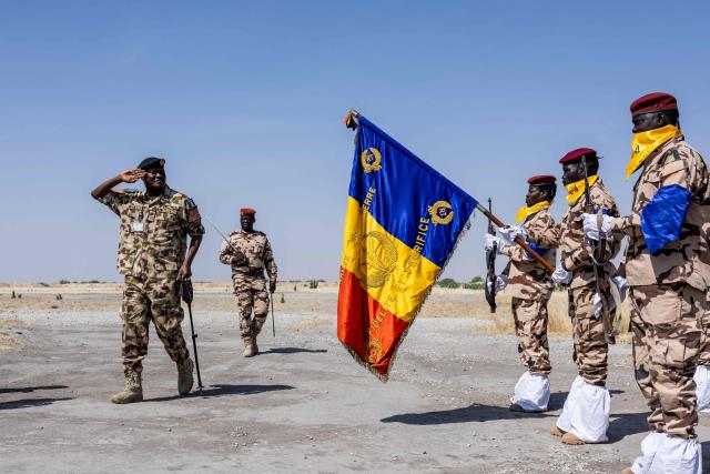 Nigerian Army Major General Saidu Tanko Audu, 56, the new force commander of the Multinational Joint Task Force (MNJTF) salutes upon his arrival at the Baga Sola military base, Lake Chad Province, Chad, on 26 November, 2025. The new commander-in-chief of the Multinational Joint Task Force (MNJTF) for counter-jihadist efforts in the Lake Chad Basin assured on Wednesday to AFP that securing waterways is a priority mission in this border region of Central Africa. Establishing secure navigation corridors is "one of the main priorities," according to General Saidou Tanko Audu, who has been leading the regional counter-jihadist force since mid-November. (Photo by Joris Bolomey / AFP)