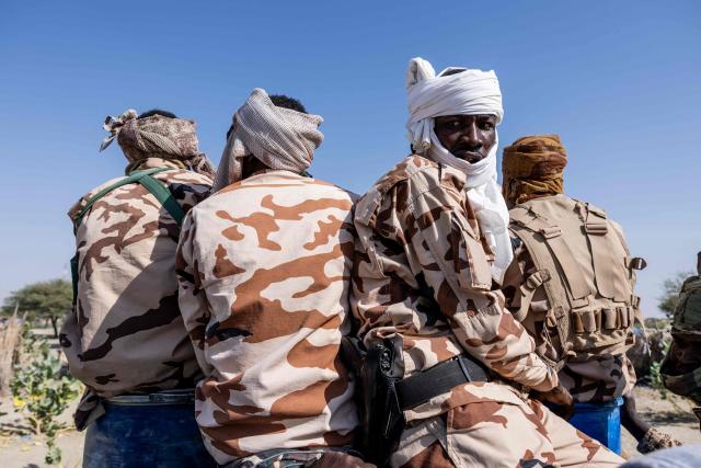 Chadian soldiers from the anti-terrorist unit gestures as he waits on the back of a vehicle at the Baga Sola military base, Lake Chad Province, Chad, on 26 November, 2025. The new commander-in-chief of the Multinational Joint Task Force (MNJTF) for counter-jihadist efforts in the Lake Chad Basin assured on Wednesday to AFP that securing waterways is a priority mission in this border region of Central Africa. Establishing secure navigation corridors is "one of the main priorities," according to General Saidou Tanko Audu, who has been leading the regional counter-jihadist force since mid-November. (Photo by Joris Bolomey / AFP)