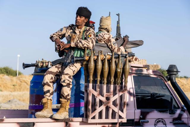A Chadian soldier from the anti-terrorist unit waits on the back of a vehicle at the Baga Sola military base, Lake Chad Province, Chad, on 26 November, 2025. The new commander-in-chief of the Multinational Joint Task Force (MNJTF) for counter-jihadist efforts in the Lake Chad Basin assured on Wednesday to AFP that securing waterways is a priority mission in this border region of Central Africa. Establishing secure navigation corridors is "one of the main priorities," according to General Saidou Tanko Audu, who has been leading the regional counter-jihadist force since mid-November. (Photo by Joris Bolomey / AFP)