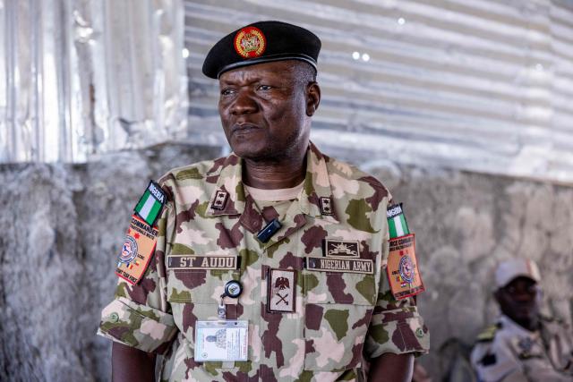 Nigerian Army Major General Saidu Tanko Audu, 56, the new force commander of the Multinational Joint Task Force (MNJTF) addresses local authorities in Kiskra, Lake Chad Province, Chad, on 26 November, 2025. The new commander-in-chief of the Multinational Joint Task Force (MNJTF) for counter-jihadist efforts in the Lake Chad Basin assured on Wednesday to AFP that securing waterways is a priority mission in this border region of Central Africa. Establishing secure navigation corridors is "one of the main priorities," according to General Saidou Tanko Audu, who has been leading the regional counter-jihadist force since mid-November. (Photo by Joris Bolomey / AFP)