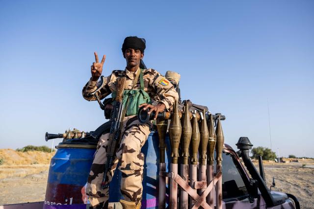 A Chadian soldier from the anti-terrorist unit gestures as he waits on the back of a vehicle at the Baga Sola military base, Lake Chad Province, Chad, on 26 November, 2025. The new commander-in-chief of the Multinational Joint Task Force (MNJTF) for counter-jihadist efforts in the Lake Chad Basin assured on Wednesday to AFP that securing waterways is a priority mission in this border region of Central Africa. Establishing secure navigation corridors is "one of the main priorities," according to General Saidou Tanko Audu, who has been leading the regional counter-jihadist force since mid-November. (Photo by Joris Bolomey / AFP)