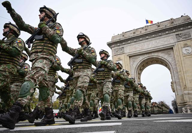 Romanian Army forces march during a military parade marking the National Day of Romania in Bucharest December 1, 2025. (Photo by Daniel MIHAILESCU / AFP)