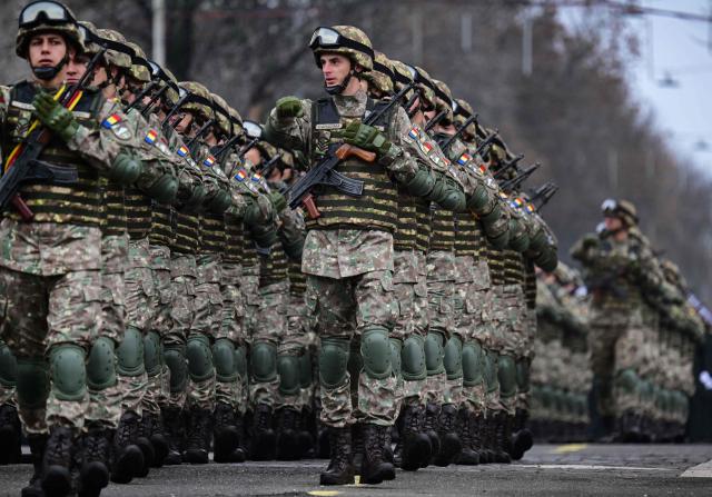 Romanian Army forces march during a military parade marking the National Day of Romania in Bucharest, on December 1, 2025. (Photo by Daniel MIHAILESCU / AFP)