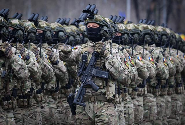Romanian Army forces march during a military parade marking the National Day of Romania in Bucharest, on December 1, 2025. (Photo by Daniel MIHAILESCU / AFP)