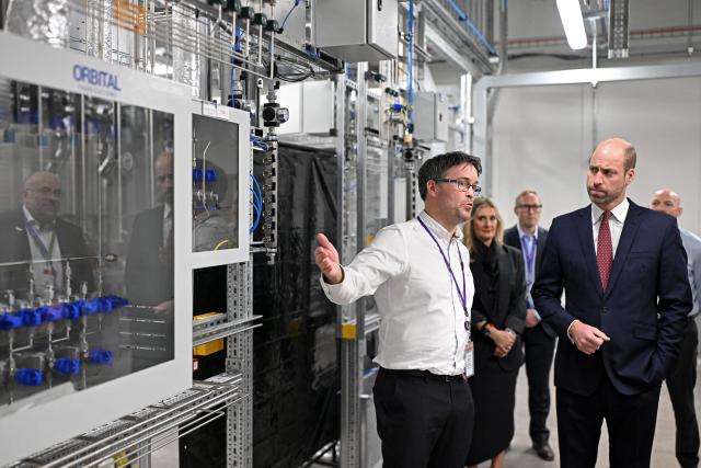 Britain's Prince William, Prince of Wales, (R) listens as John Peploe (L), Facilities Director of KLA, talks during his visit to the newly opened SPTS, a division of international semiconductor company KLA, in the city of Newport, Wales, on December 1, 2025. (Photo by Matthew Horwood / POOL / AFP)