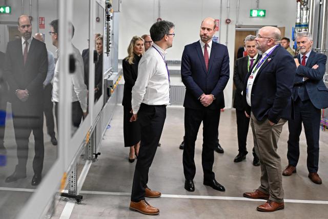 Britain's Prince William (C), Prince of Wales, gets a tour by John Peploe (L), facilities director of KLA, and Andrew Evans (R) of SPTS during a visit to the semiconductor manufacturer SPTS, a division of KLA, ahead of the Wales Investment Summit in the city of Newport, Wales, on December 1, 2025. (Photo by Matthew Horwood / POOL / AFP)