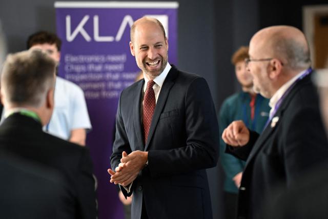 Britain's Prince William, Prince of Wales, talks to employees during a visit at the semiconductor manufacturer SPTS, a division of KLA, in the city of Newport, Wales, on December 1, 2025. (Photo by Matthew Horwood / POOL / AFP)