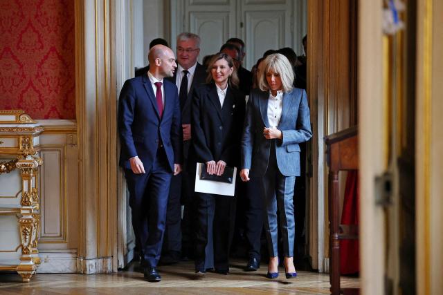 France's Foreign Affairs Minister Jean-Noel Barrot (L) arrives with Ukraine French President's wife Olena Zelenska (C) and French President's wife Brigitte Macron (R) to attend the launch of the cultural event "Ukraine Season in France - Journey to Ukraine" at the Quai d'Orsay Ministry in Paris on December 1, 2025. (Photo by Gonzalo Fuentes / POOL / AFP)