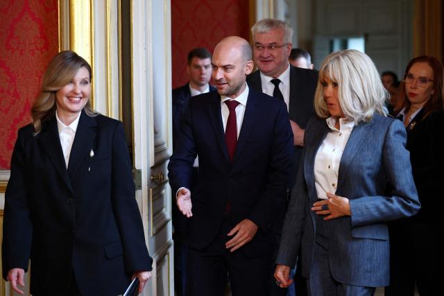 France's Foreign Affairs Minister Jean-Noel Barrot (C) arrives with Ukraine French President's wife Olena Zelenska (L) and French President's wife Brigitte Macron to attend the launch of the cultural event "Ukraine Season in France - Journey to Ukraine" at the Quai d'Orsay Ministry in Paris on December 1, 2025. (Photo by Gonzalo Fuentes / POOL / AFP)