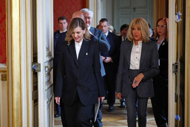 Ukraine French President's wife Olena Zelenska (L) and French President's wife Brigitte Macron (R) arrive to attend the launch of the cultural event "Ukraine Season in France - Journey to Ukraine" at the Quai d'Orsay Ministry in Paris on December 1, 2025. (Photo by Gonzalo Fuentes / POOL / AFP)