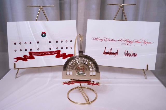 A Christmas card from US President Donald Trump and First Lady Melania Trump are displayed at the White House in Washington, DC, December 1, 2025, during a Christmas decoration media tour. (Photo by SAUL LOEB / AFP)