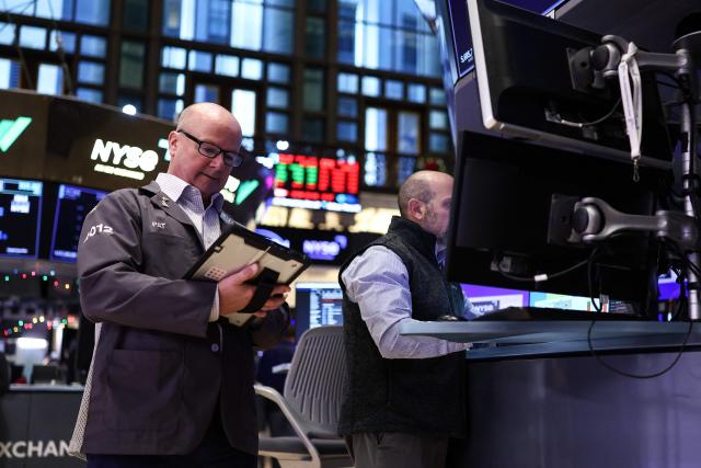 Traders work on the floor of the New York Stock Exchange (NYSE) in New York on December 1, 2025. European and US stock markets turned lower Monday as investors awaited key US data that could play a role in Federal Reserve deliberations ahead of an expected cut to interest rates next week. Wall Street began the final month of the year on the back foot, with the blue-chip Dow sliding 0.6 percent. (Photo by CHARLY TRIBALLEAU / AFP)