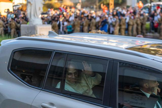 Pope Leo XIV waves at cheering crowds as his motorcade passes through Jounieh, north of Beirut, on December 1, 2025. Leo prayed for peace in Lebanon and the region on December 1 on day two of his trip to the multi-confessional country, with joyful Lebanese welcoming the pontiff at two famous pilgrimage sites. (Photo by Jewel SAMAD / AFP)