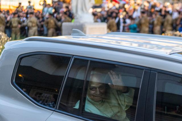Pope Leo XIV waves at cheering crowds as his motorcade passes through Jounieh, north of Beirut, on December 1, 2025. Leo prayed for peace in Lebanon and the region on December 1 on day two of his trip to the multi-confessional country, with joyful Lebanese welcoming the pontiff at two famous pilgrimage sites. (Photo by Jewel SAMAD / AFP)