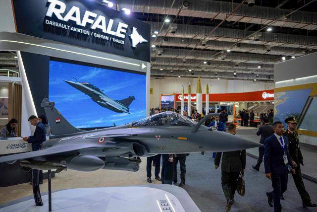 A model of the French made Rafale jet fighter is displayed during the opening day of the 4th edition of Egypt Defence Expo (EDEX-2025), at the Cairo International Exhibition Centre, in Cairo on December 1, 2025.  (Photo by Khaled DESOUKI / AFP)