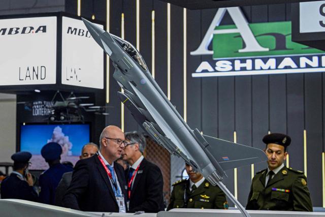 An Egyptian army officer (R) attends the opening day of the 4th edition of Egypt Defence Expo (EDEX-2025), at the Cairo International Exhibition Centre in Cairo on December 1, 2025. (Photo by Khaled DESOUKI / AFP)