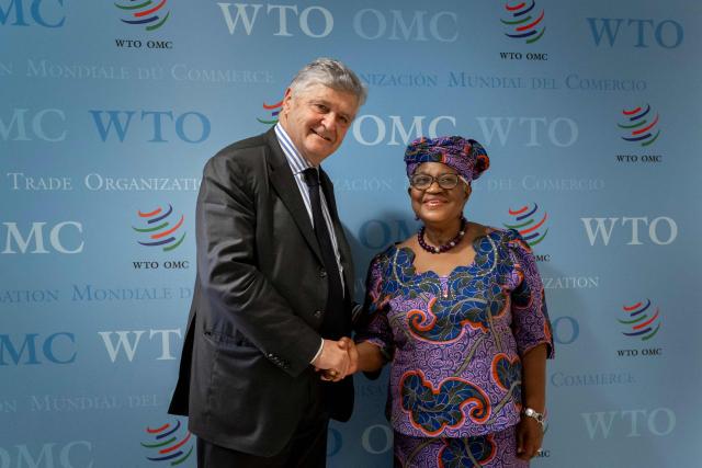 France's junior Minister in charge of external trade Nicolas Forissier (L) shakes hands with World Trade Organization (WTO) Director-General Ngozi Okonjo-Iweala after a meeting at the WTO's headquarters in Geneva on December 1, 2025. (Photo by Fabrice COFFRINI / AFP)
