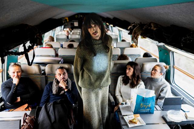 A model presents a creation on a TGV train as part of the "Circular Fashion Week" event on its way from Paris to Lille, on December 1, 2025. Giving visibility to circular fashion players: that is the goal of the first “Circular Fashion Week,” held from the December 1 to 7 in Lille's metropolitan area, with fashion shows, workshops, a professional forum, and a “committed” fashion market. To kick off this week of circular fashion, the first fashion show on a moving train was organised on a Paris-Lille TGV speed train. (Photo by Sameer Al-DOUMY / AFP)