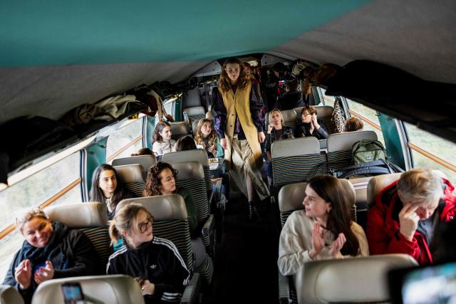 Models present creations on a TGV train as part of the "Circular Fashion Week" event on its way from Paris to Lille, on December 1, 2025. Giving visibility to circular fashion players: that is the goal of the first “Circular Fashion Week,” held from the December 1 to 7 in Lille's metropolitan area, with fashion shows, workshops, a professional forum, and a “committed” fashion market. To kick off this week of circular fashion, the first fashion show on a moving train was organised on a Paris-Lille TGV speed train. (Photo by Sameer Al-DOUMY / AFP)