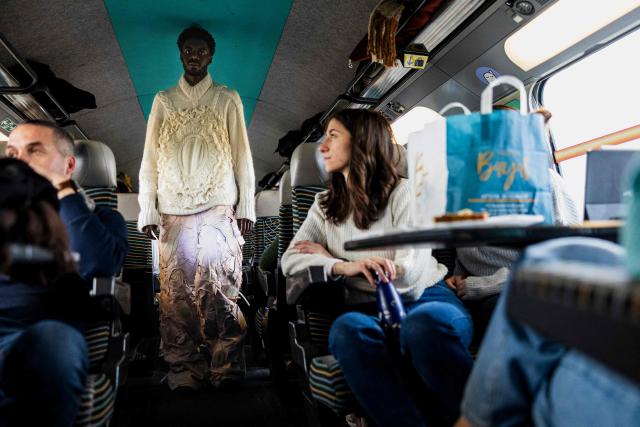 A model presents a creation on a TGV train as part of the "Circular Fashion Week" event on its way from Paris to Lille, on December 1, 2025. Giving visibility to circular fashion players: that is the goal of the first “Circular Fashion Week,” held from the December 1 to 7 in Lille's metropolitan area, with fashion shows, workshops, a professional forum, and a “committed” fashion market. To kick off this week of circular fashion, the first fashion show on a moving train was organised on a Paris-Lille TGV speed train. (Photo by Sameer Al-DOUMY / AFP)