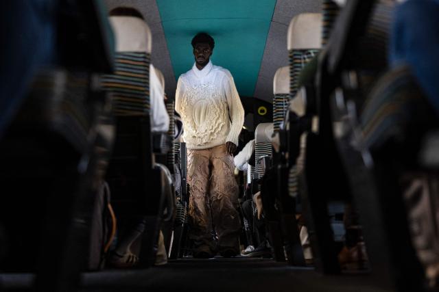 A model presents a creation on a TGV train as part of the "Circular Fashion Week" event on its way from Paris to Lille, on December 1, 2025. Giving visibility to circular fashion players: that is the goal of the first “Circular Fashion Week,” held from the December 1 to 7 in Lille's metropolitan area, with fashion shows, workshops, a professional forum, and a “committed” fashion market. To kick off this week of circular fashion, the first fashion show on a moving train was organised on a Paris-Lille TGV speed train. (Photo by Sameer Al-DOUMY / AFP)