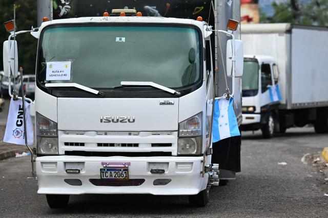 Trucks return to the Electoral Logistics Center with ballots to be counted a day after the presidential elections, in Tegucigalpa, on December 1, 2025. Candidate Nasry Asfura, supported by US President Donald Trump, and his rival Salvador Nasralla, also from the right-wing, are locked in a close race for victory in Honduras' presidential elections on Monday. (Photo by Marvin RECINOS / AFP)