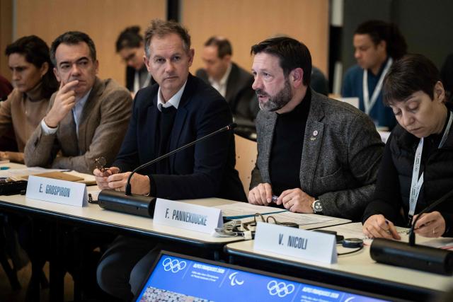 Fabrice Pannekoucke (2R), regional councilor for Auvergne-Rhône-Alpes and Edgar Grospiron, former Olympic skiing champion and President of the Coordination Committee for the 2030 Winter Olympics (2L) speak during the coordination committee meeting for the 2030 Winter Olympics in the French Alps, in Val d'Isère, central eastern France, on December 1, 2025. (Photo by ARNAUD FINISTRE / AFP)