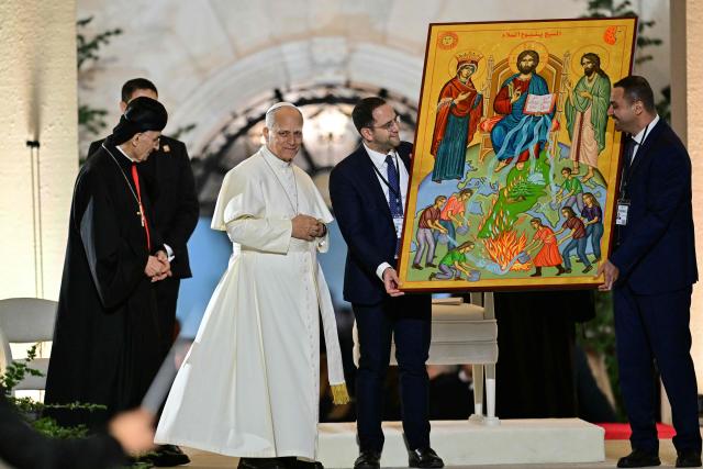 Pope Leo XIV receives a gift during a gathering with youths at the Maronite Patriarchate in Bkerke, north of the capital Beirut, on December 1, 2025. Leo prayed for peace in Lebanon and the region on December 1 on day two of his trip to the multi-confessional country, with joyful Lebanese welcoming the pontiff at two famous pilgrimage sites. (Photo by Giuseppe CACACE / AFP)
