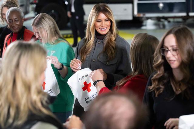 US First Lady Melania Trump helps make care packages for deployed members of the US military during an American Red Cross holiday event with military families at Joint Base Andrews in Maryland, December 1, 2025. (Photo by SAUL LOEB / AFP)