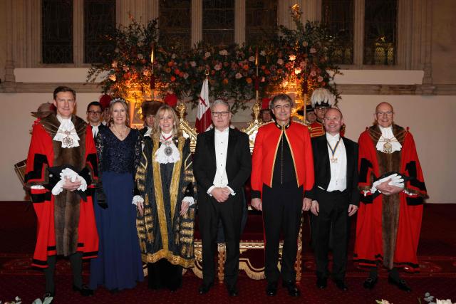 (L-R) Alderman & Sheriff Robert Hughes-Penney, Elspeth Hughes-Penney, Lady Mayor of London, Susan Langley, Britain's Prime Minister Keir Starmer, Mayor Consort Gary Langley, Kevin Bradford, Sheriff & Deputy Keith Bottomley pose for a family photograph at the Lady Mayor’s Banquet at the Guildhall in central London on December 1, 2025. The 697th Lord Mayor of the City of London, Dame Susan Langley becomes the third woman in the City Corporation’s history to hold the office – and the first to use the title, 'Lady Mayor'.?? (Photo by Adrian DENNIS / AFP)