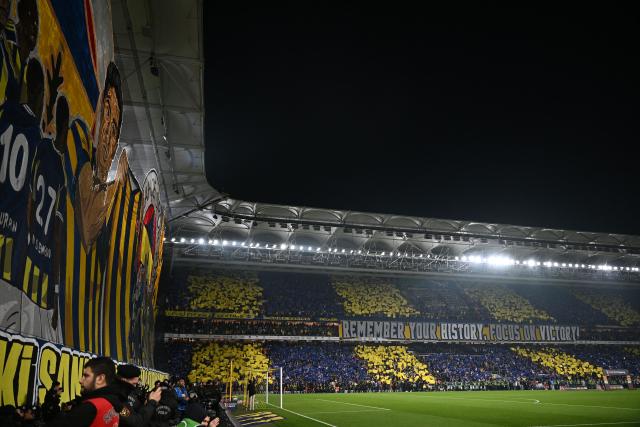 Fenerbahce's fans cheers for their team before the Turkish Super lig football match between Fenerbahce and Galatasaray at the Fenerbahce Sukru Saracoglu stadium in Istanbul, on December 1, 2025. (Photo by Ozan KOSE / AFP)