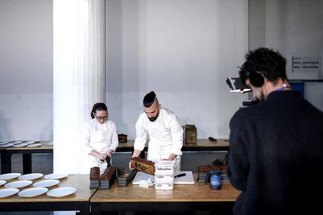 French chef Jonathan Dudek representing France, removes from the tin his pate-croute creation during the 16th Edition of the 2025 Pate-Croute World Championship, in Lyon, central-eastern France, on December 1, 2025. (Photo by Alex MARTIN / AFP)