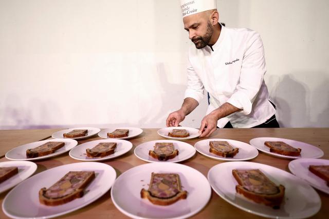 French chef Thibault Gonzales representing France, prepares the dishes with his pate-croute creation during the 16th Edition of the 2025 Pate-Croute World Championship, in Lyon, central-eastern France, on December 1, 2025. (Photo by Alex MARTIN / AFP)