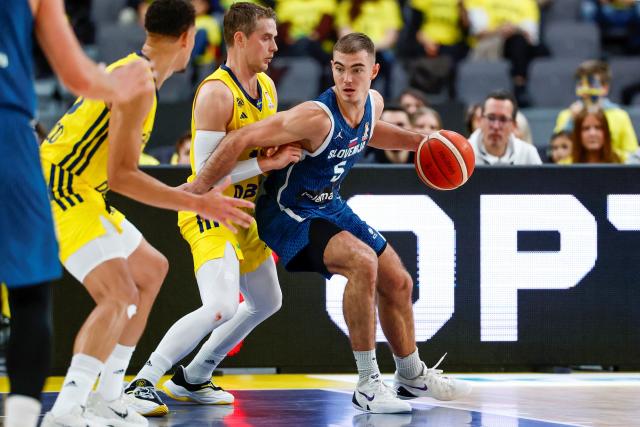 Sweden's Ludvig Hakanson and Slovenia's Ziga Samar vie for the ball during the 2027 FIBA Basketball World Cup qualifying match between Sweden and Slovenia at Scandinavium, Gothenburg, Sweden on December 1, 2025. (Photo by Adam IHSE / TT News Agency / AFP) / Sweden OUT