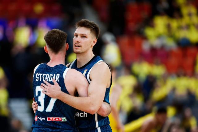 Slovenia's Gregor Glas hugs Slovenia's Leon Stergar after the team's 83-94 win of the 2027 FIBA Basketball World Cup qualifying match between Sweden and Slovenia which ended at Scandinavium, Gothenburg, Sweden on December 1, 2025. (Photo by Adam IHSE / TT News Agency / AFP) / Sweden OUT