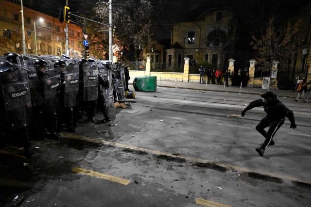 A protester clashes with Bulgarian Gendarmerie during an anti-government protest in Sofia on December 1, 2025. Tens of thousands of people held anti-government protests in Bulgaria on Monday, widening an anti-corruption movement sweeping the European Union's poorest country as it prepares to adopt the euro. (Photo by Nikolay DOYCHINOV / AFP)