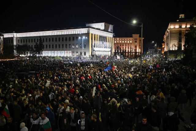 Protesters gather during an anti-government protest in Sofia on December 1, 2025. Tens of thousands of people held anti-government protests in Bulgaria on Monday, widening an anti-corruption movement sweeping the European Union's poorest country as it prepares to adopt the euro. (Photo by Nikolay DOYCHINOV / AFP)