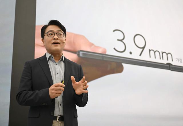 Kang Min-seok, head of the smartphone product planning team at Samsung Electronics, speaks during a launch event of Samsung Galaxy Z TriFold smartphone at a Samsung store in Seoul on December 2, 2025. Samsung Electronics unveiled its first tri-fold phone on December 2, as the conglomerate rushes to show it can keep pace with rivals in generative AI. (Photo by Jung Yeon-je / AFP)