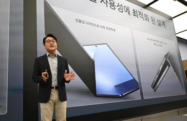 Kang Min-seok, head of the smartphone product planning team at Samsung Electronics, speaks during a launch event of Samsung Galaxy Z TriFold smartphone at a Samsung store in Seoul on December 2, 2025. Samsung Electronics unveiled its first tri-fold phone on December 2, as the conglomerate rushes to show it can keep pace with rivals in generative AI. (Photo by Jung Yeon-je / AFP)